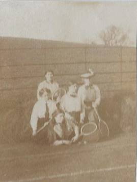 A couple of young girls in a white oval frame

Description automatically generated